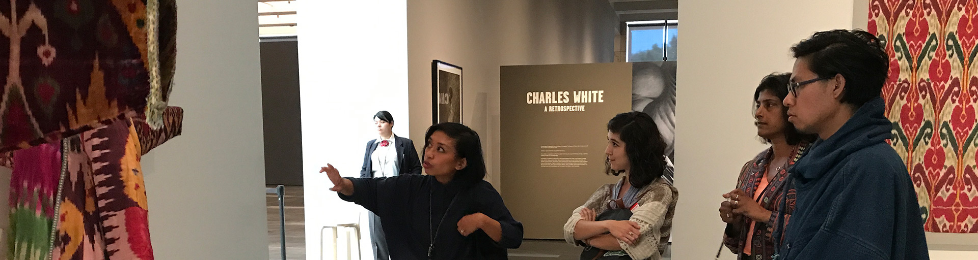 students inspecting an art piece