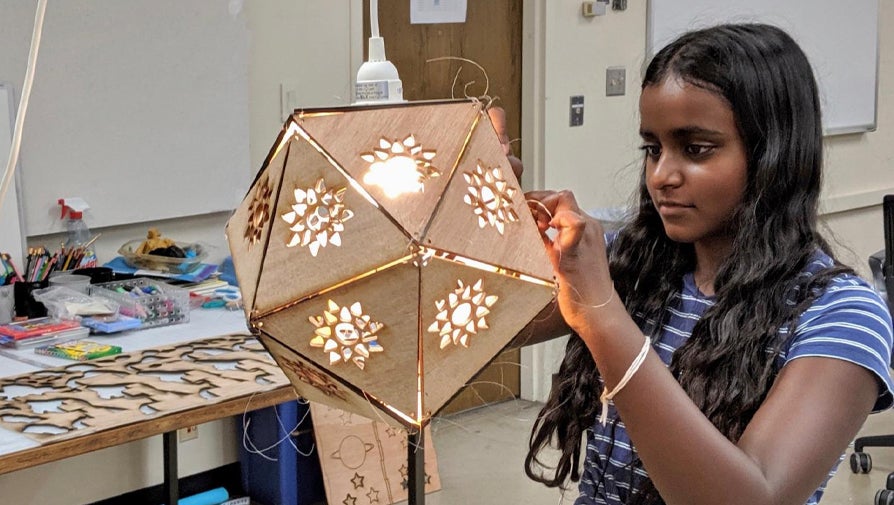student building wooden lamp