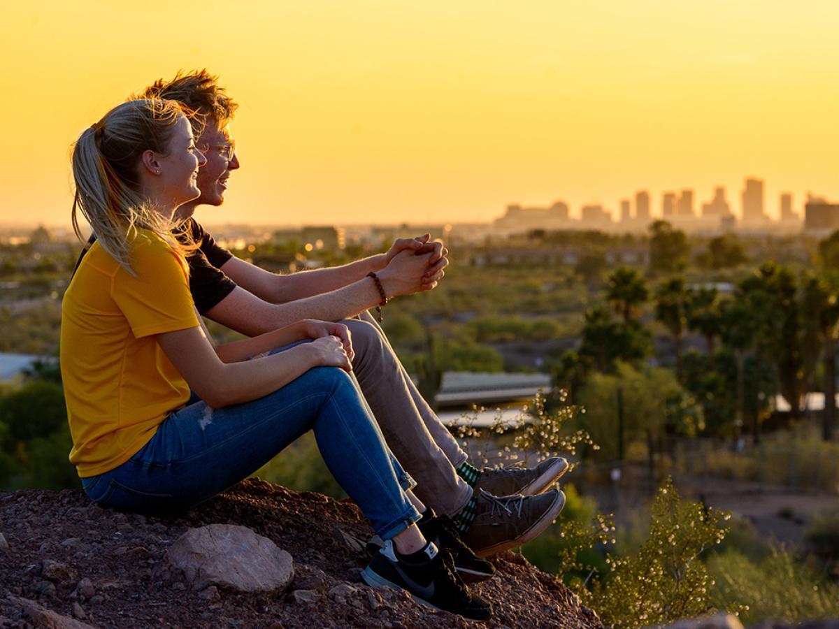 students sitting on a mountain